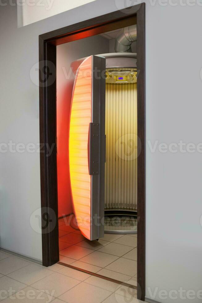 Stand up tanning bed photo