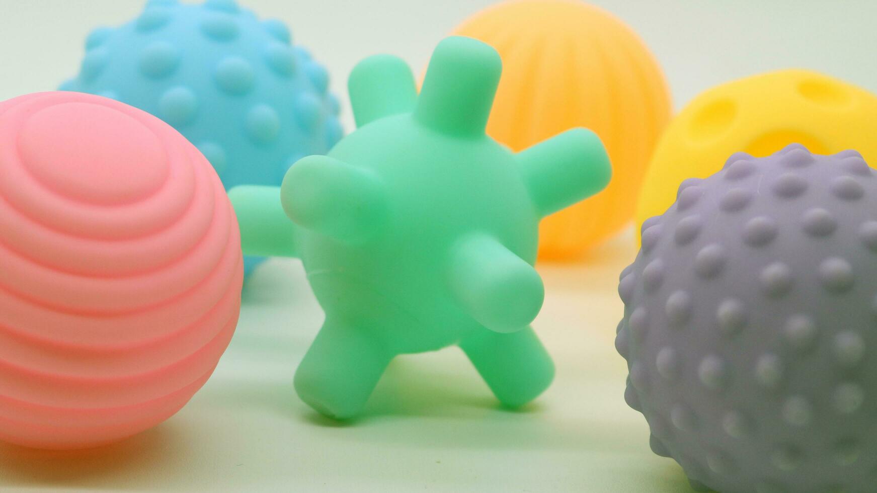 Collection of small rubber ball toys of various colors photo