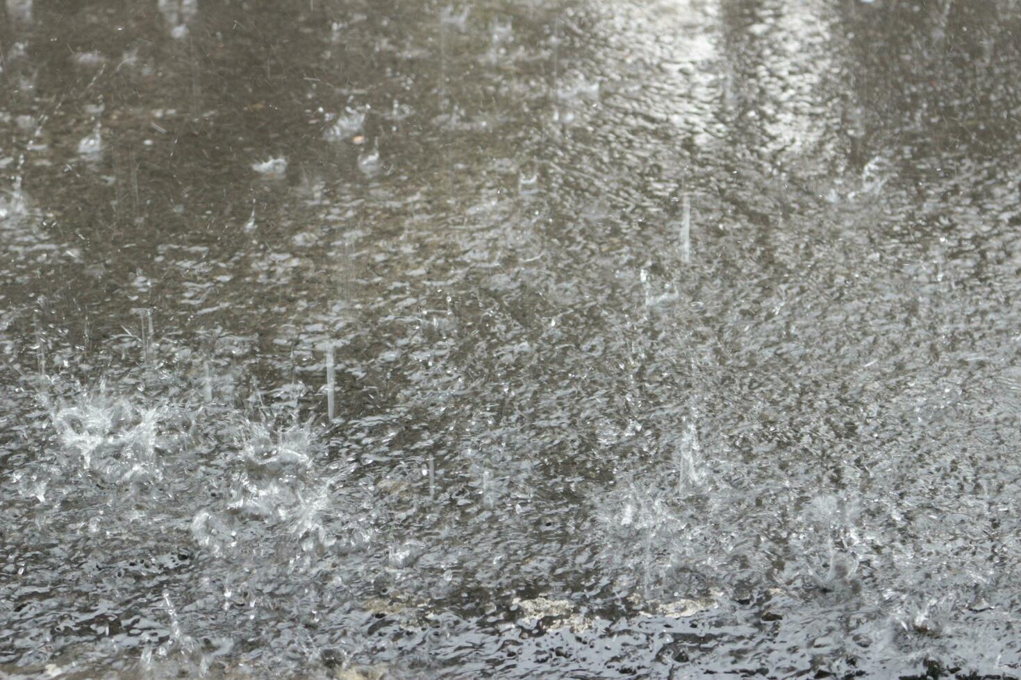 Heavy rain splashes on the street photo