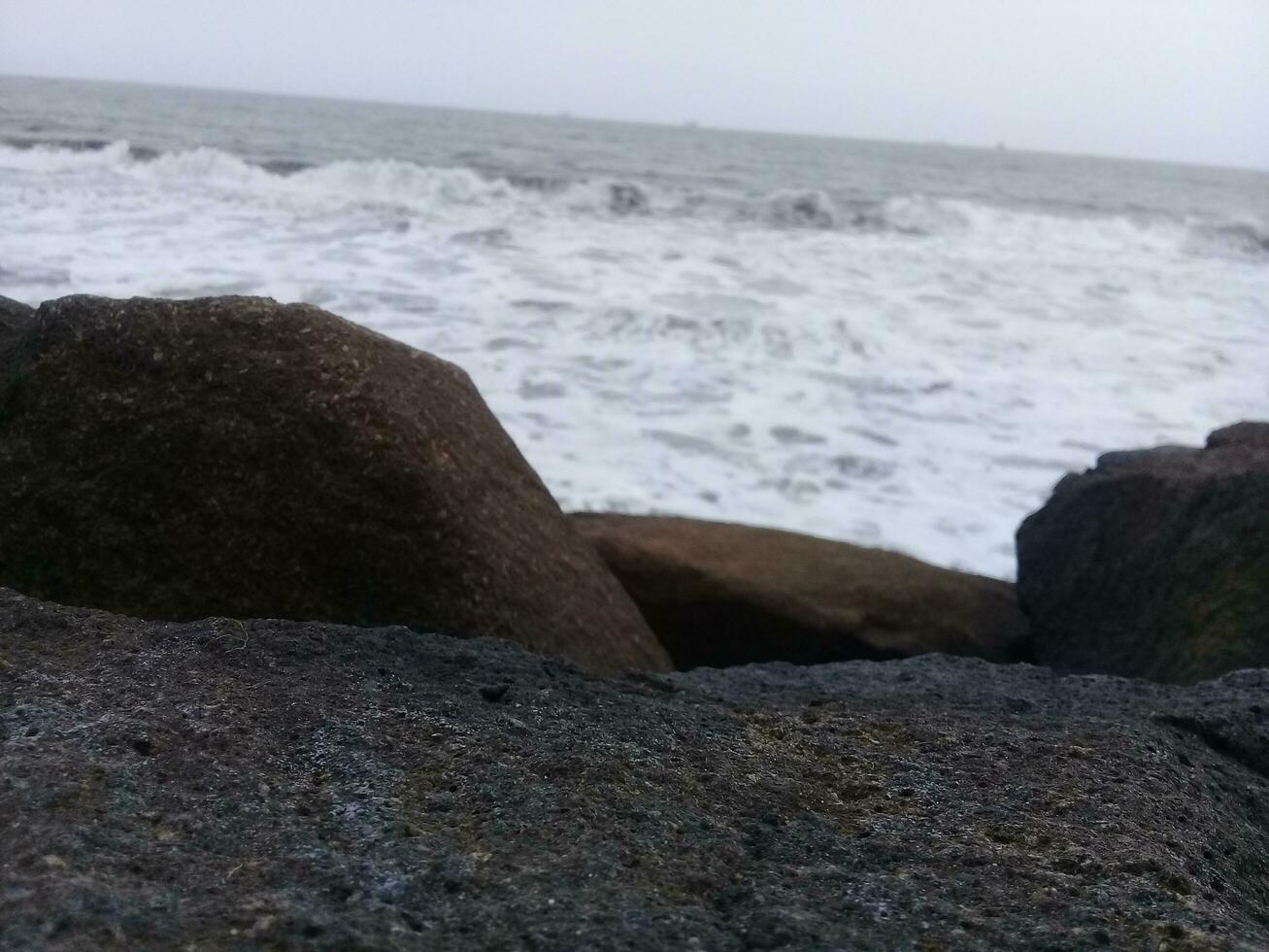 View of the waves and rocks on the beach photo