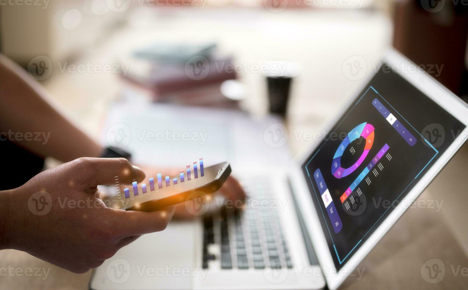 businessman using smartphone and typing on computer keyboard in concept of data analysis stock market financial and investment, business strategy and growth photo