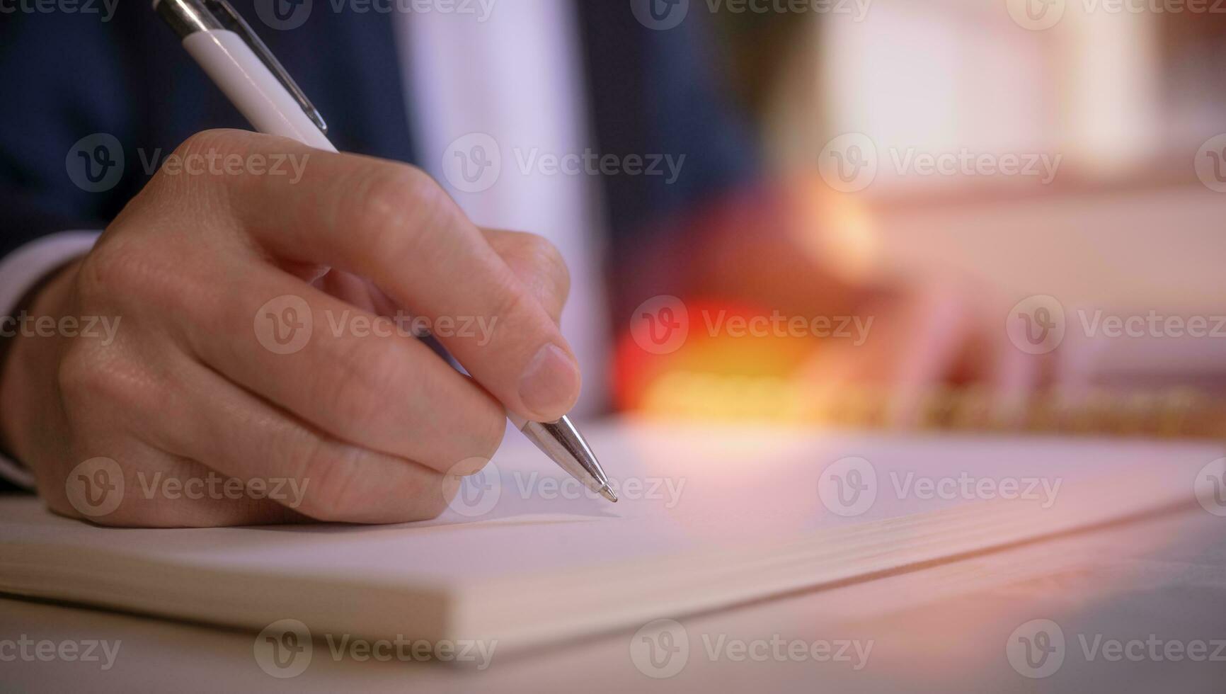 Businessman writing on notebook in office on table. Concept of finance planing and analyzes business and growth. working from home concept photo