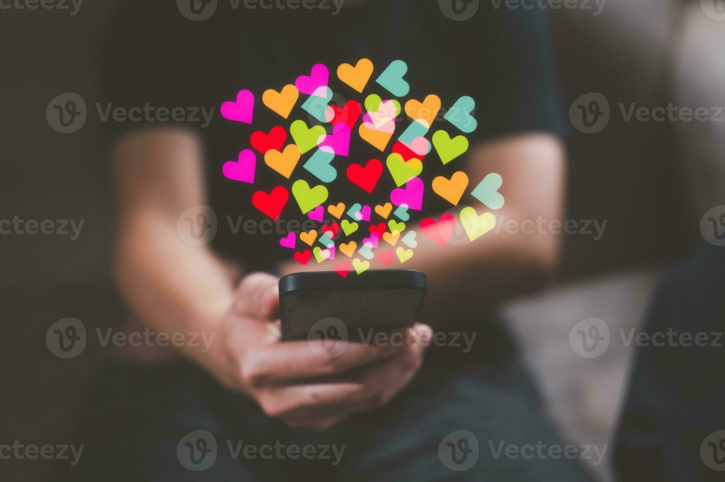 Social media concept. Hands with smartphone and like notification icon. Social networking, man using smartphone sending hearts icon on application internet network photo