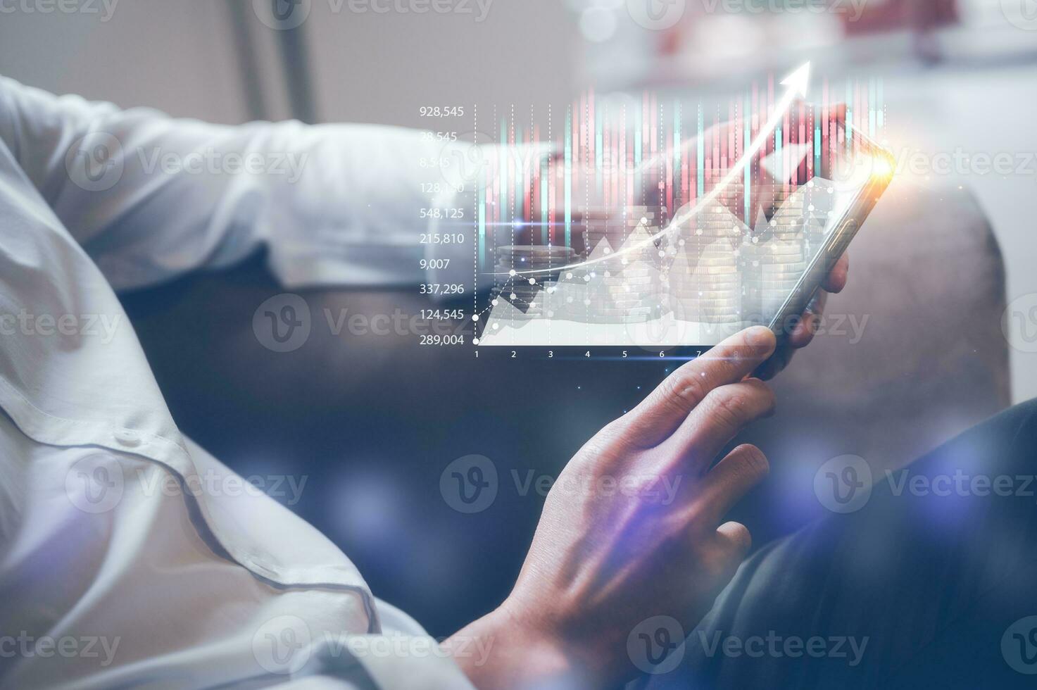 businessman sitting on couch at home holding smartphone with virtual trading graph, using cell phone mobile apps, Social media influence concept photo
