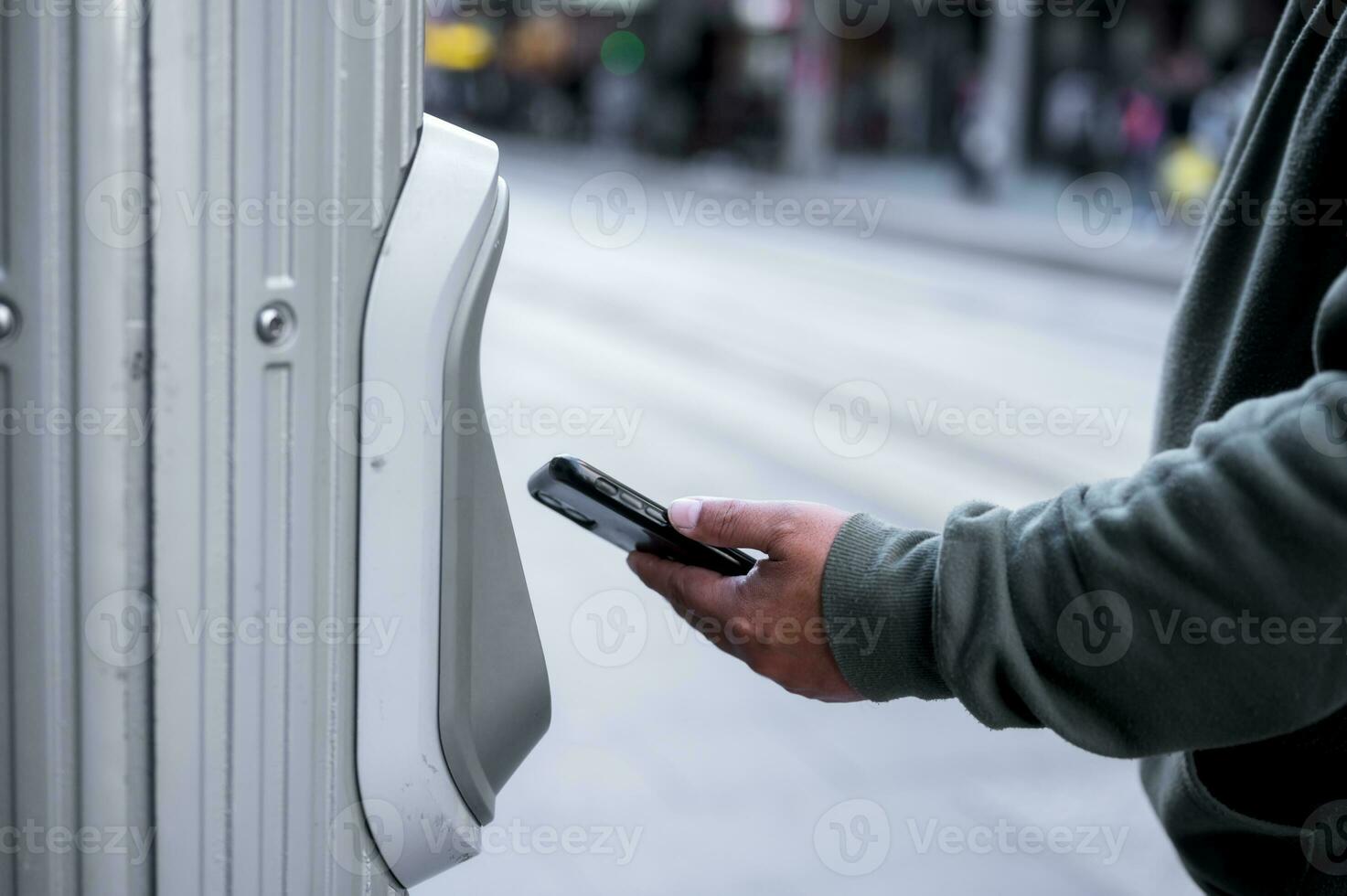 man using smartphone tap to pay at pay station for  ticket or transportation services, buy and scan to pay photo