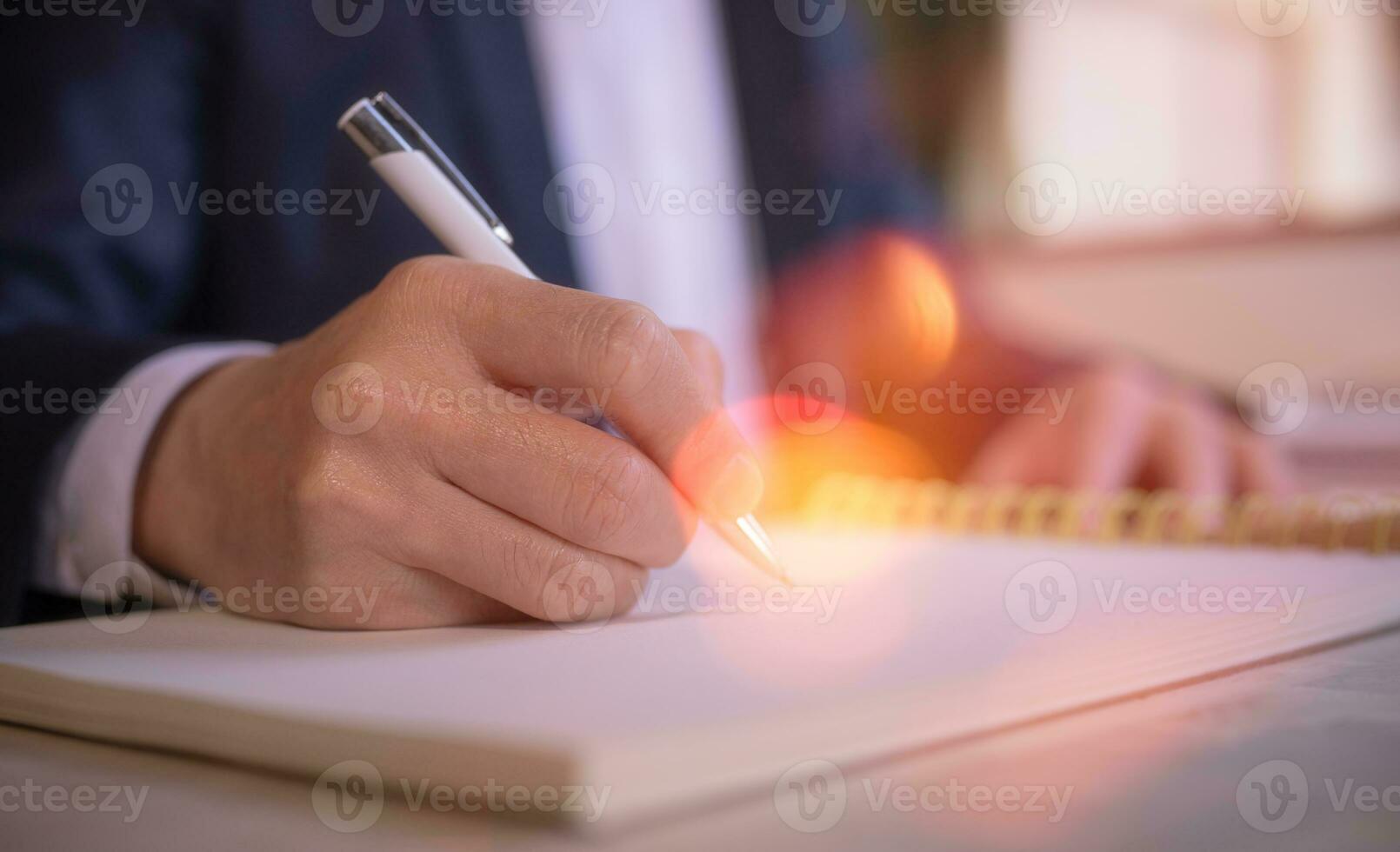 Businessman writing on notebook in office on table. Concept of finance planing and analyzes business and growth. working from home concept photo