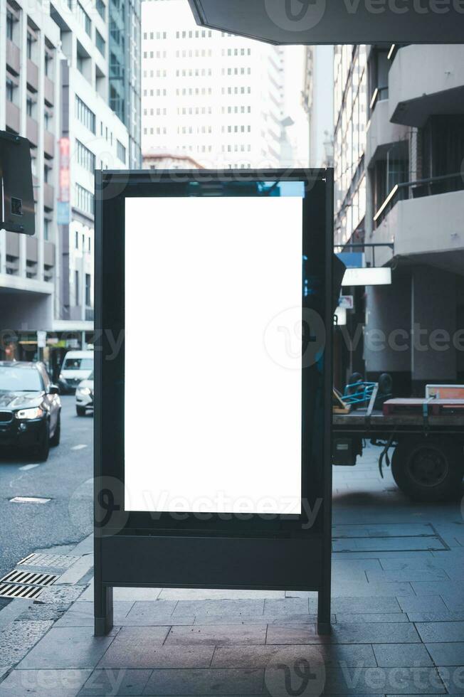 Blank advertising billboard on street in the city photo