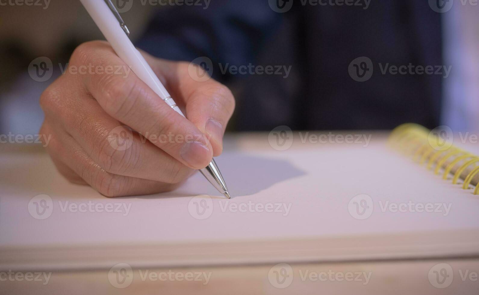 Businessman writing on notebook in office on table. Concept of finance planing and analyzes business and growth. working from home concept. photo