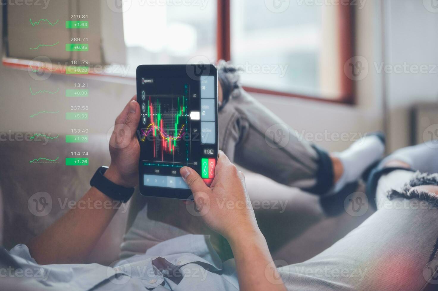 businessman sitting on couch at home holding smartphone with virtual trading graph, using cell phone mobile apps, Social media influence concept photo