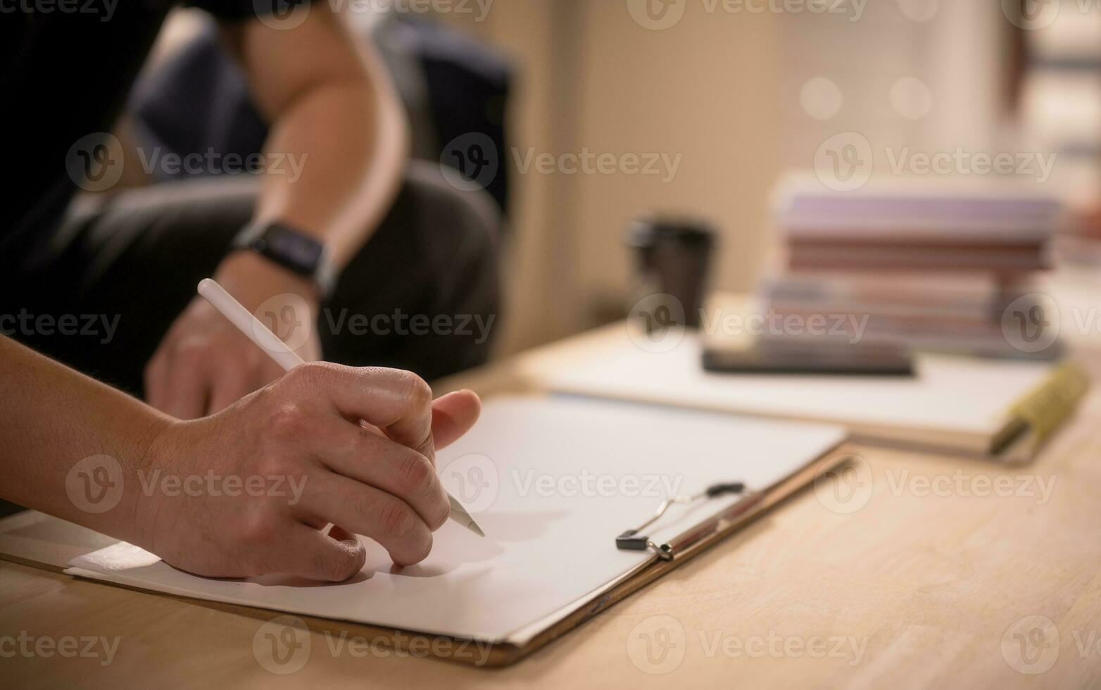 Businessman writing on notebook in office  on table. Concept of finance planing and analyzes business and growth. working from home concept. photo