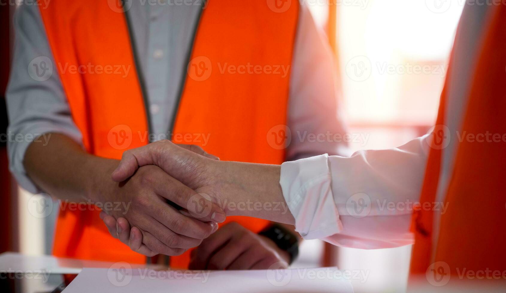 Engineers or foreman shaking hands at construction site, Construction worker in protective uniform shaking hands at construction site photo