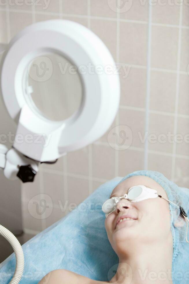 Smiling woman before cosmetologial procedure in clinic photo