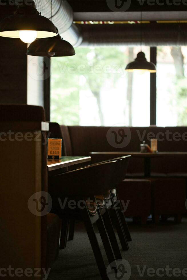 Empty cafe interior with wooden furniture and sofa photo