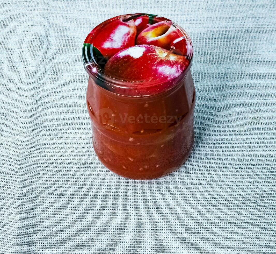 Traditional Hungarian homemade lecho in glass jars. Preserved tomatoes and peppers with spices. photo