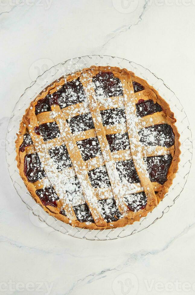 Elegant Delicacy, Classic Linzer Cake with Cherry on Marble. Delectable Traditions, Cherry-Topped Linzer Cake on Marble Background photo