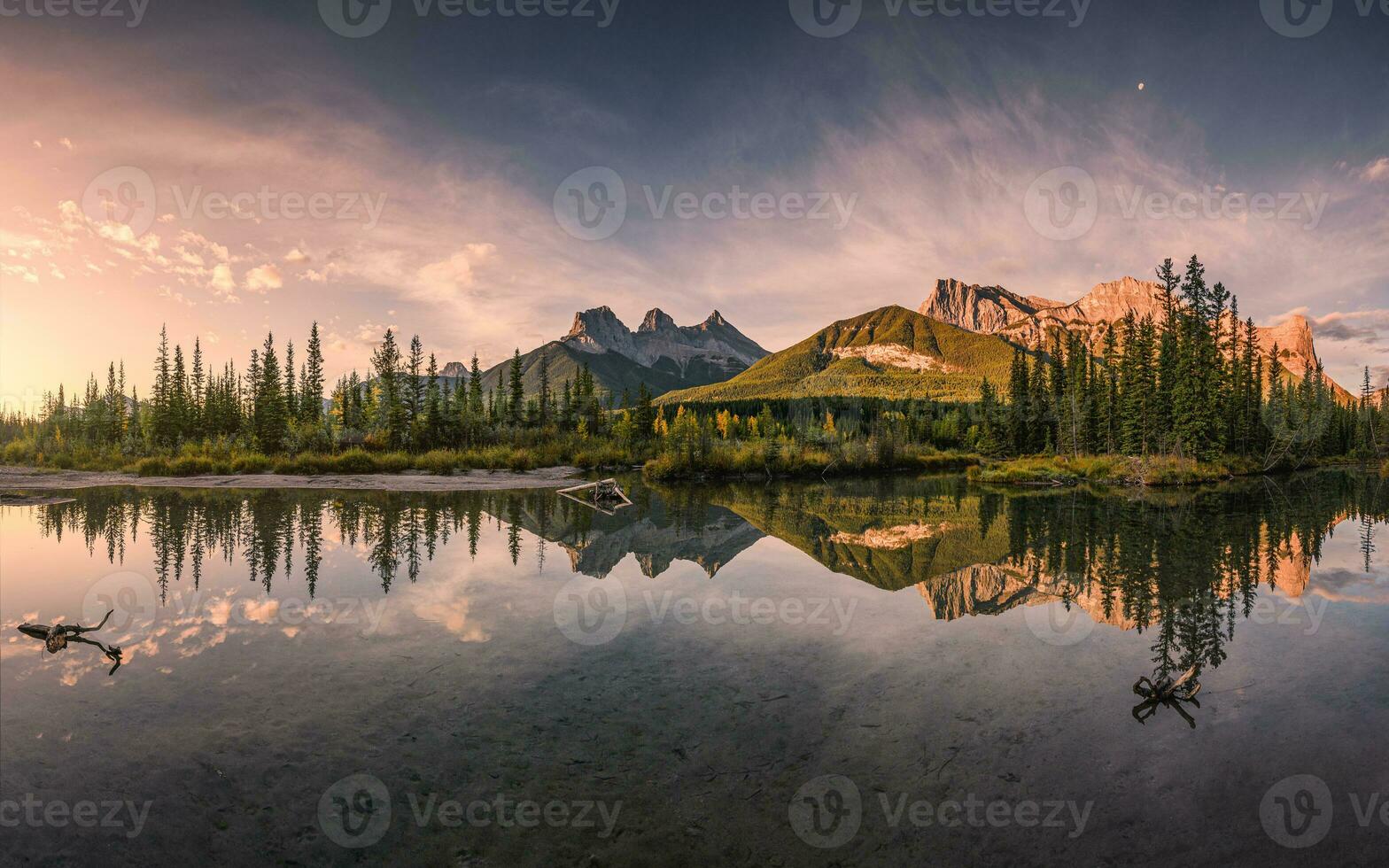 Panorama of Three sisters mountain reflection on pond at sunrise in autumn at Banff national park photo