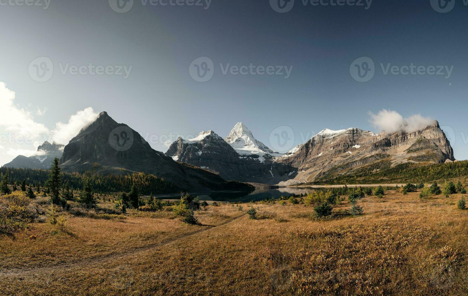 Mount Assiniboine with Lake Magog in autumn forest on sunny at provincial park photo