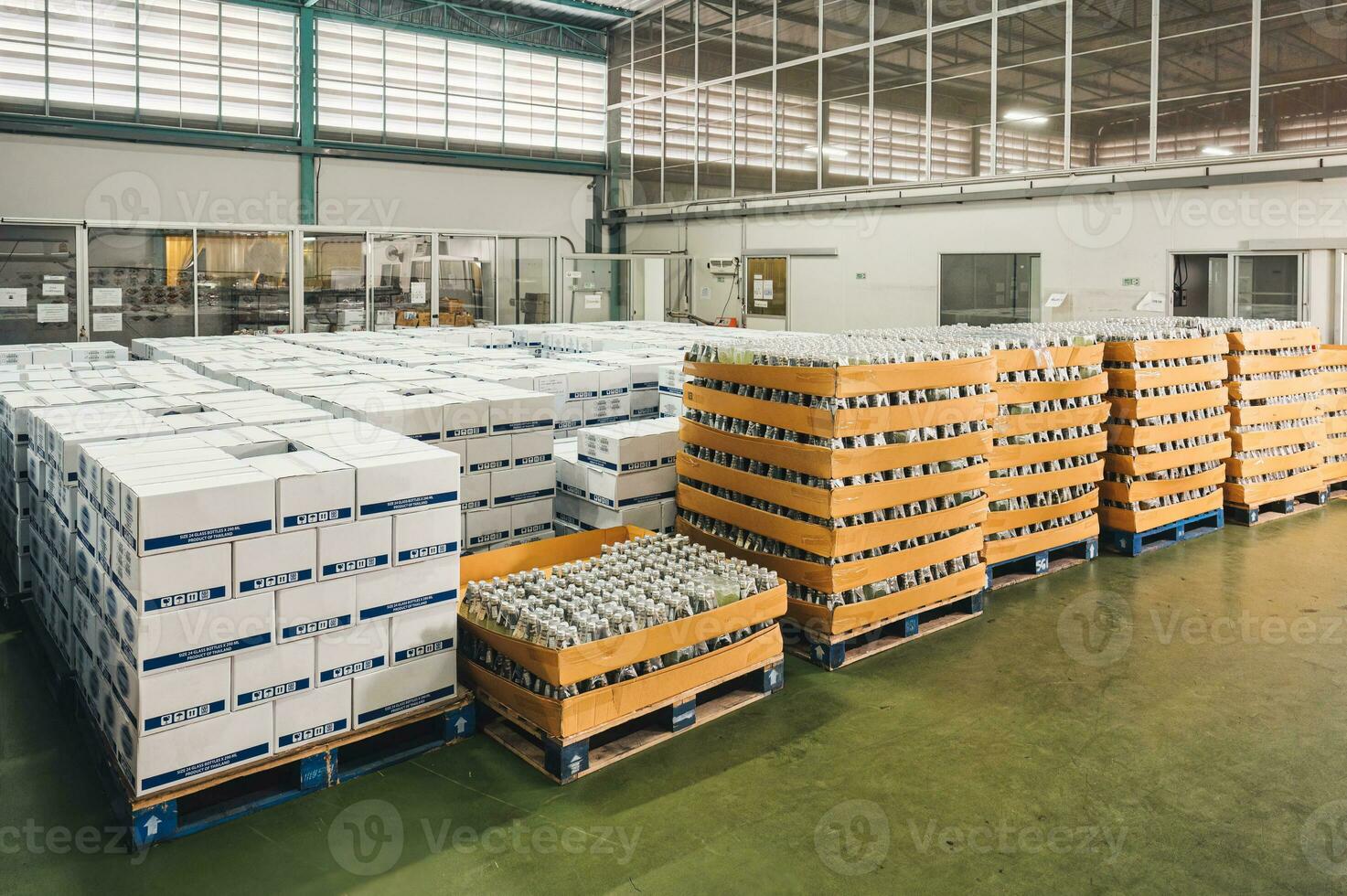 Group of bottled juice beverage product in cardboard box package in manufacturing factory photo