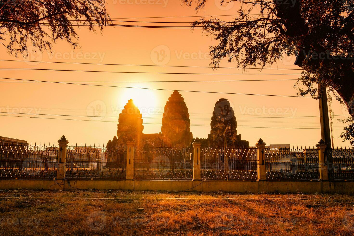 Sunset over Khmer architecture ancient monument of Phra Prang Sam Yot in Lopburi photo