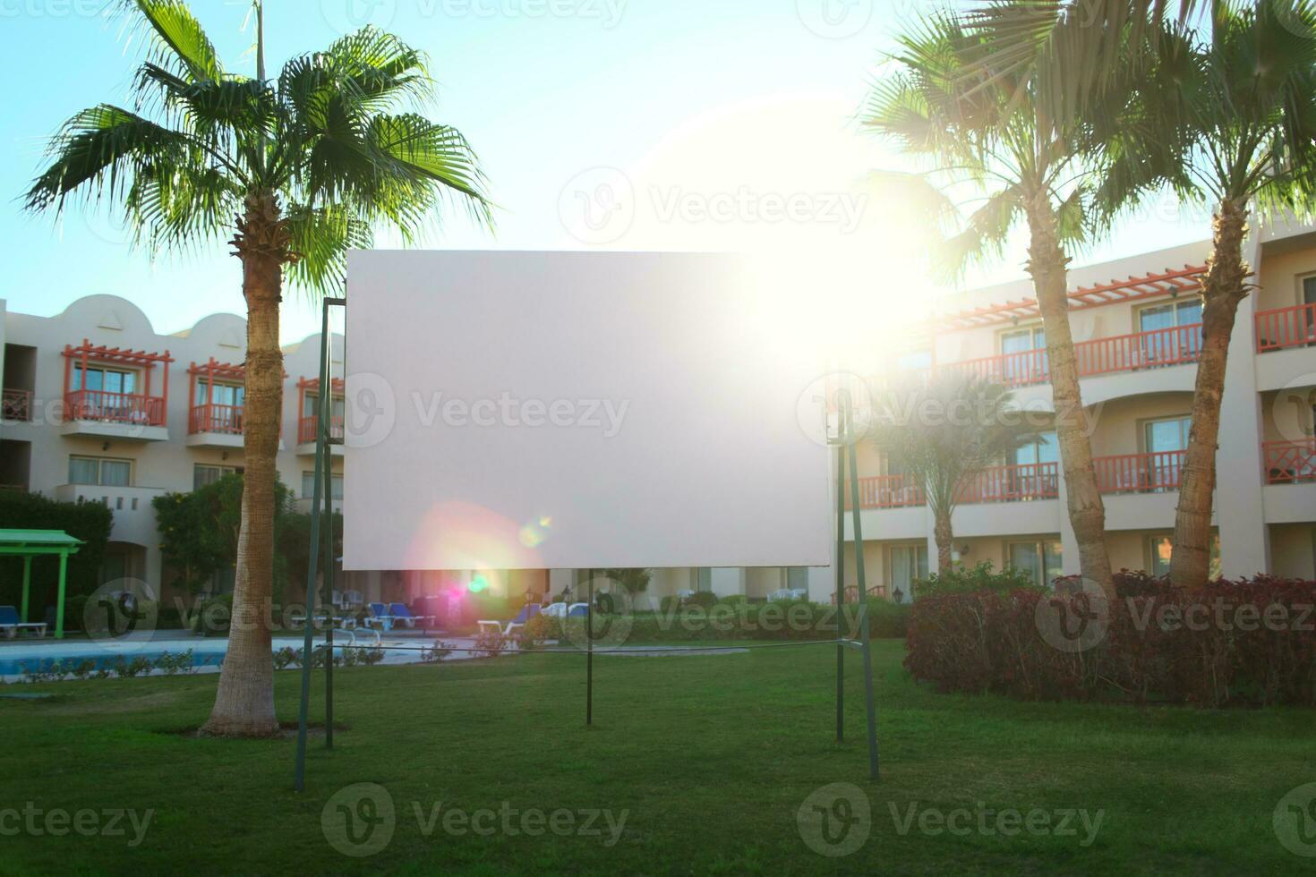 Sun flare behind a blank urban billboard photo