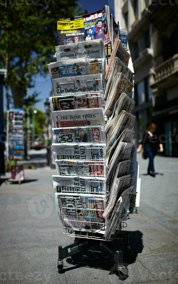 A newspaper pole on a street photo