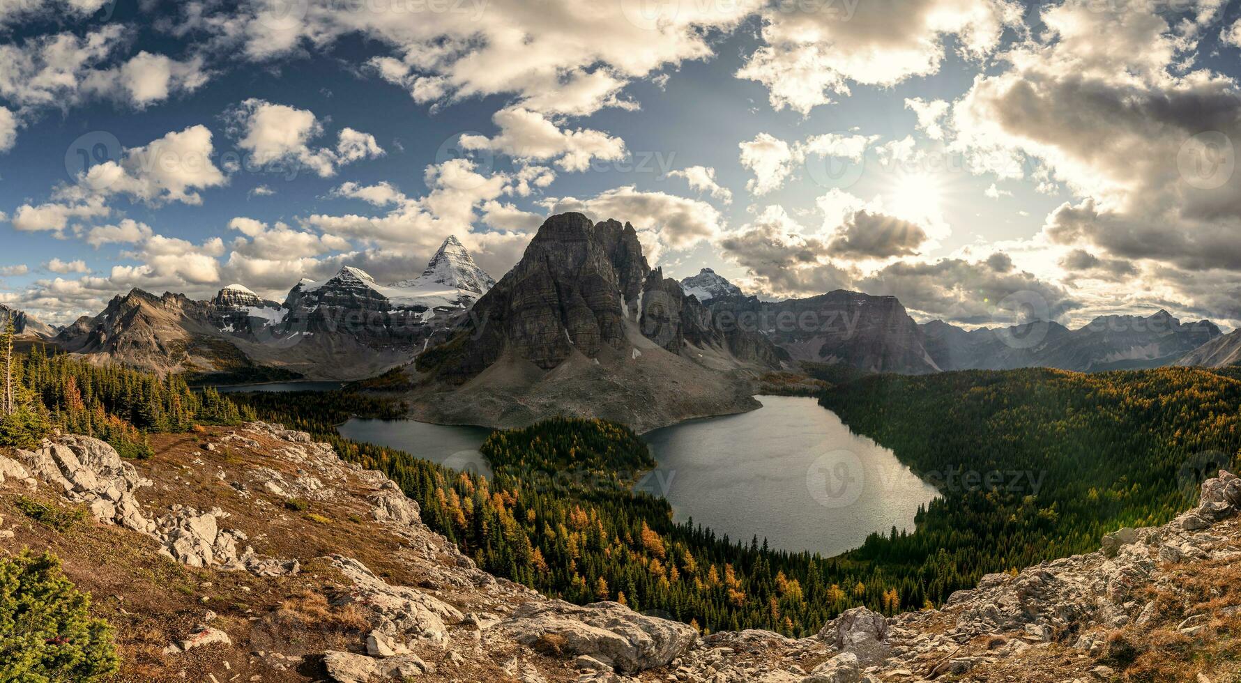 Mount Assiniboine with Sunburst and Cerulean lake in autumn pine forest at British Columbia photo