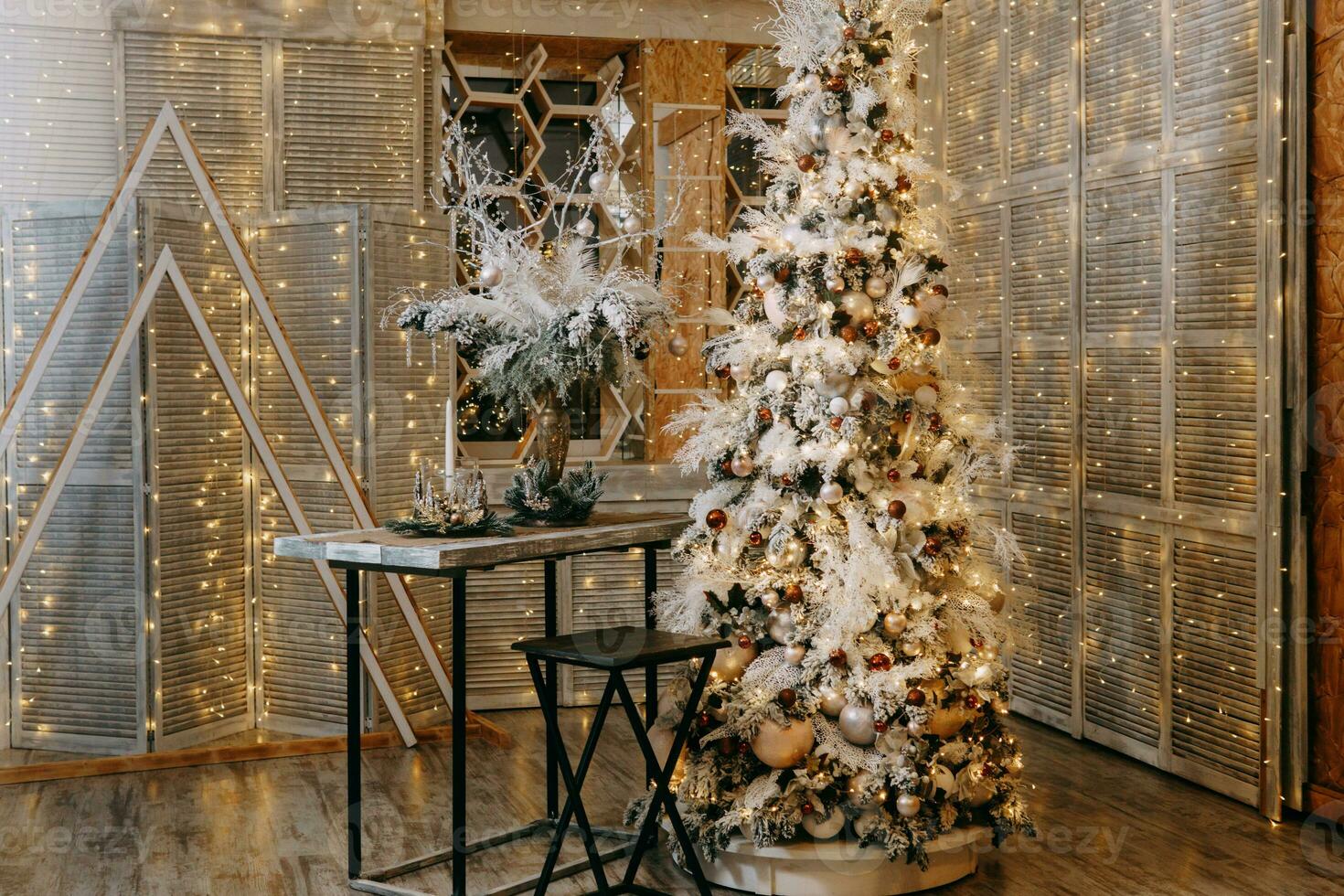 Home Christmas interior, with a Christmas tree and lots of glowing garlands and light bulbs. Preparing for the Christmas party at home. photo