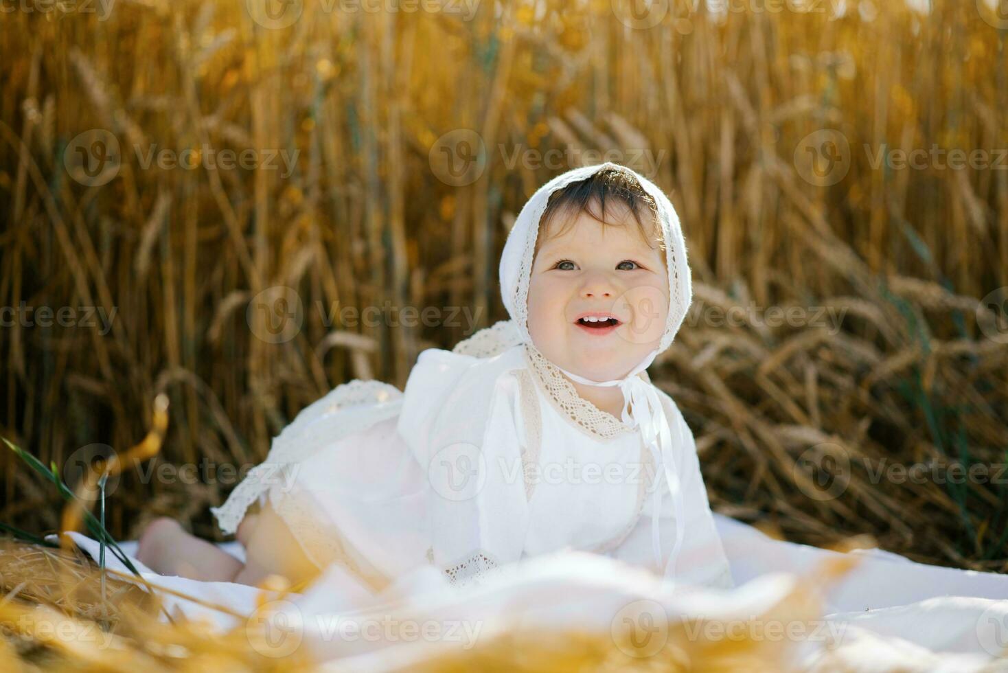 A child boy in white clothes is relaxing in the fresh air in a field photo