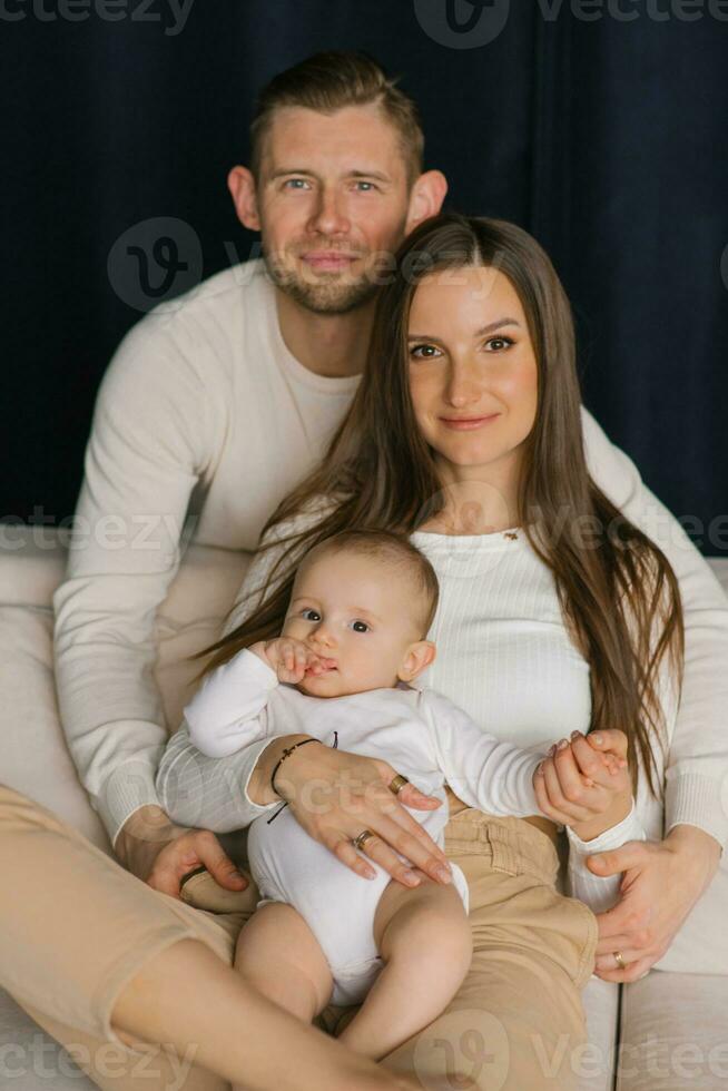 Cute stylish family dad, mom and baby boy are happy to be together photo