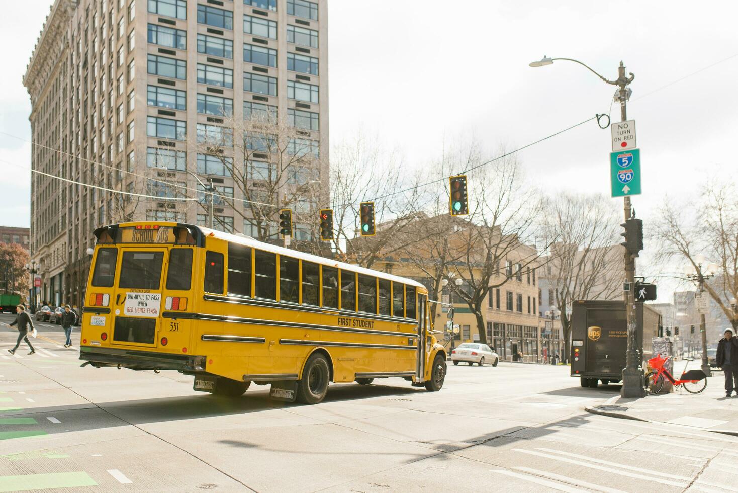 Seattle, Washington, USA. March 2020. Yellow school bus rides on the city road photo