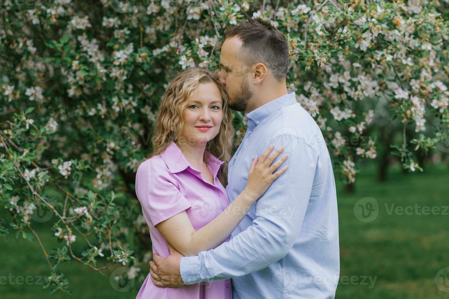 Loving man and woman on a walk in a spring blooming park photo