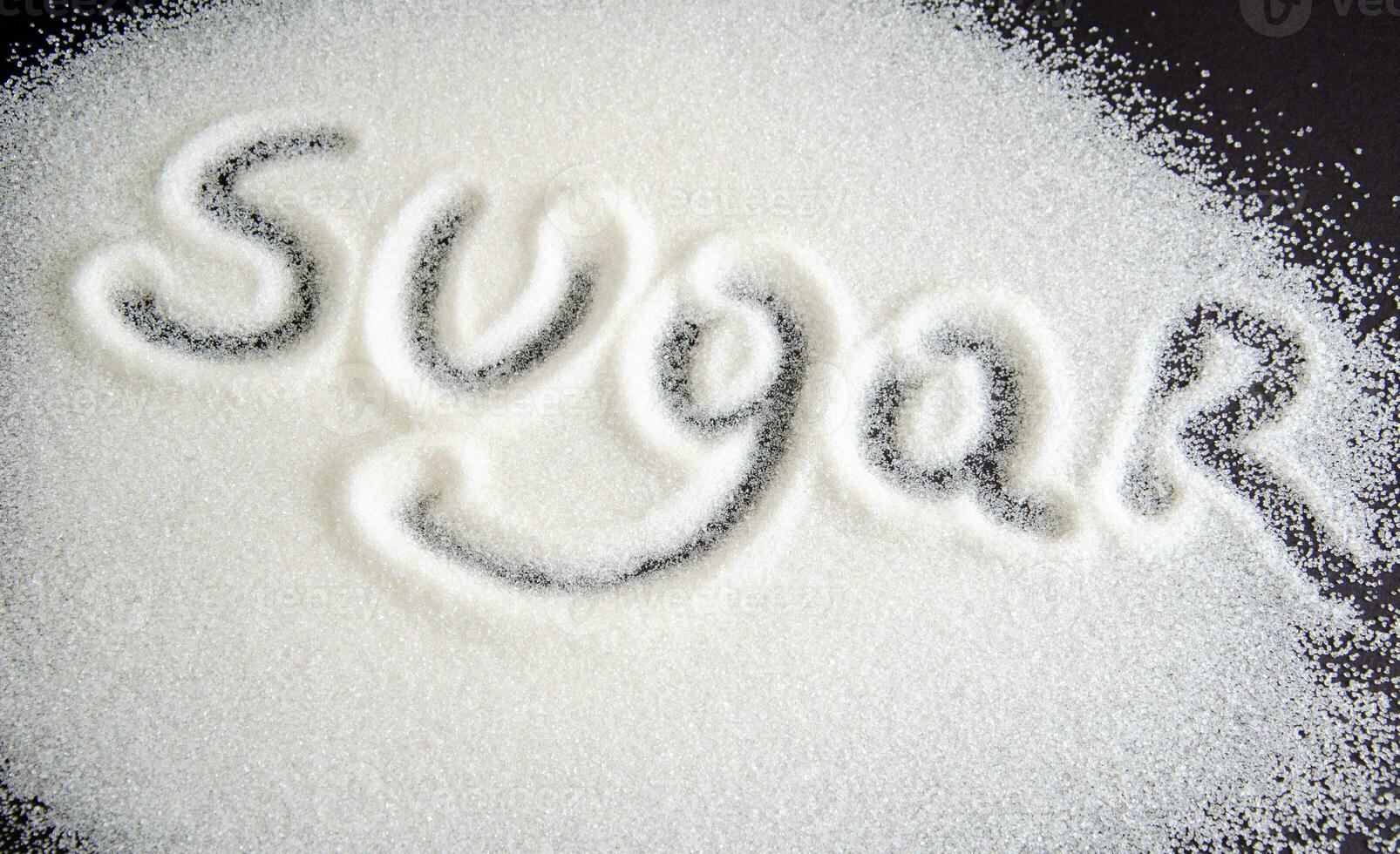 sugar on a black background. sugar crystals close up. Black background. granulated sugar. photo