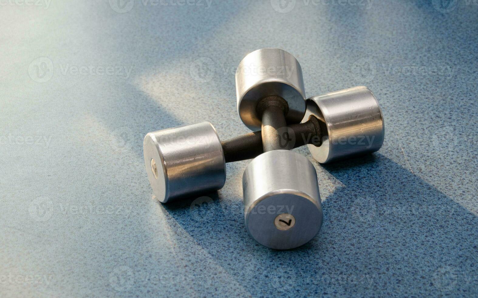 dumbbell, dumbbell in the gym on a blue background. gym for fitness. exercise equipment in the gym. photo