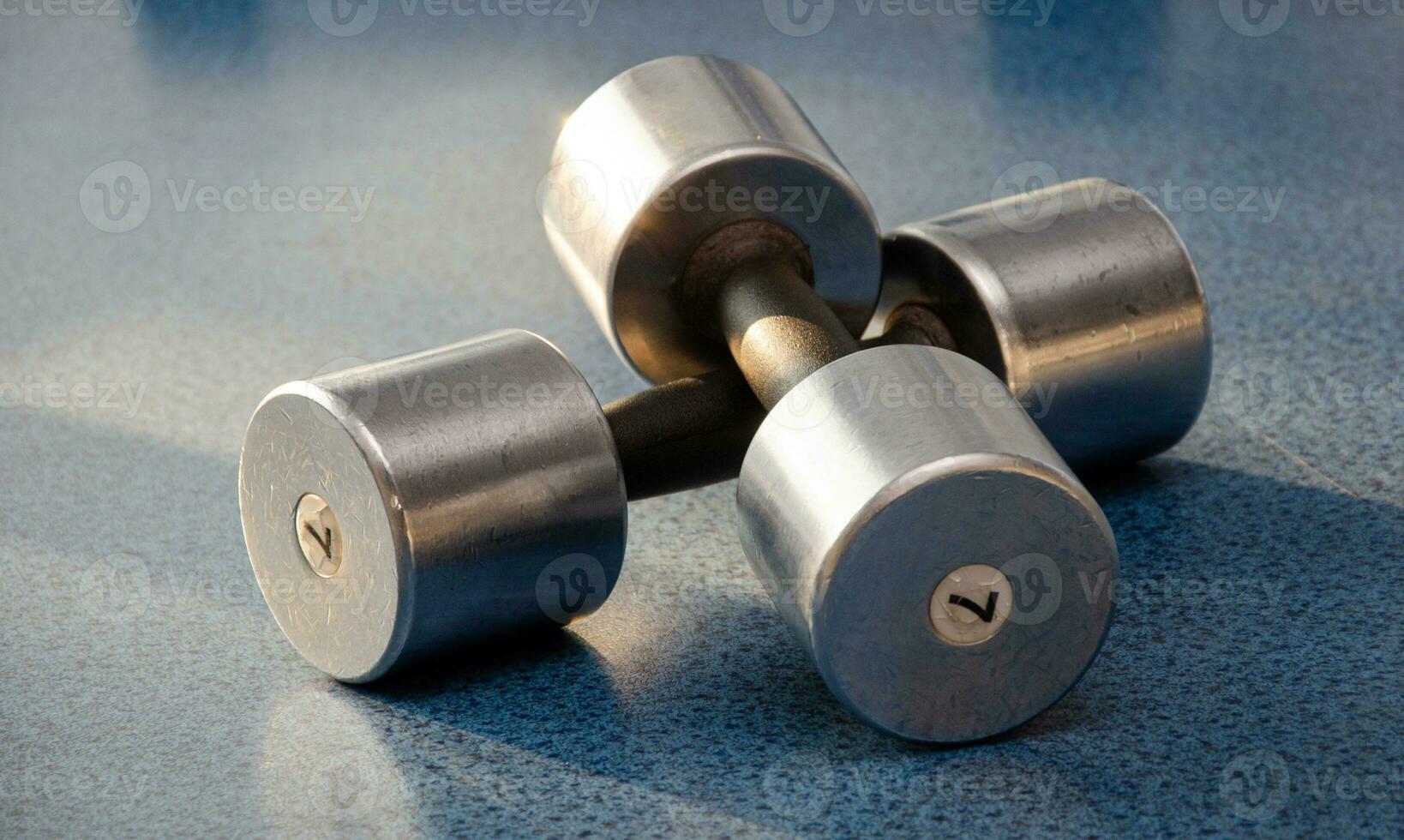 dumbbell, dumbbell in the gym on a blue background. gym for fitness. exercise equipment in the gym. photo