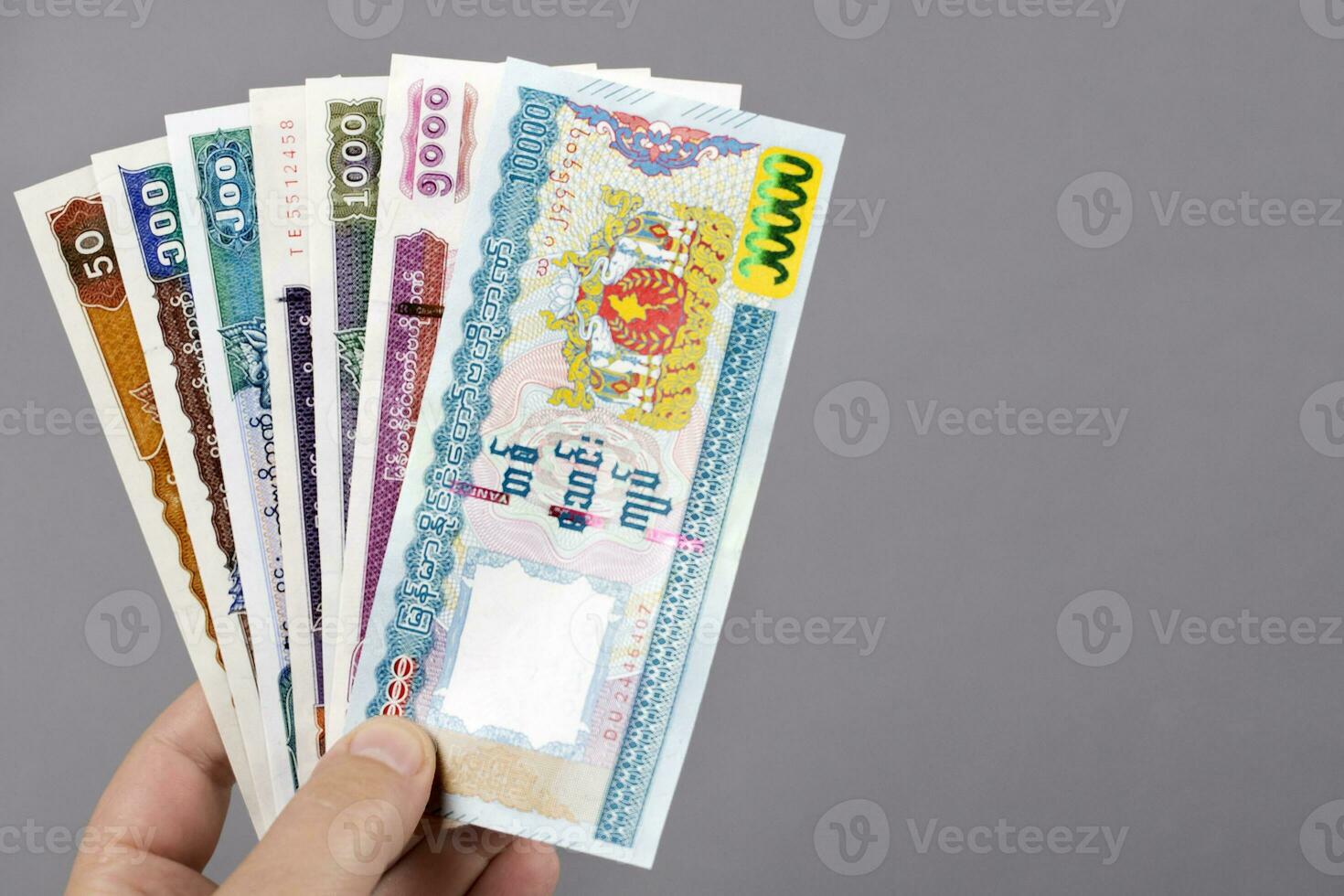 Myanmar money in the hand on a gray background photo