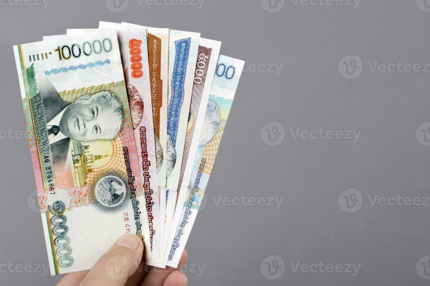 Lao money in the hand on a gray background photo