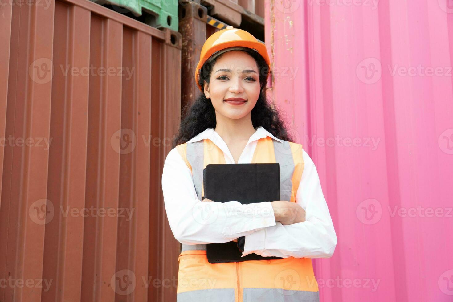 Maintanence worker working with cargo containers. Engineer in safety helmet, reflective vest, holding walkie talkie with container export and import business and logistics background. photo