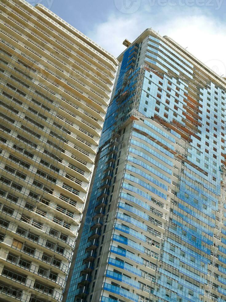 Modern multistory buildings under construction. Unfinished skyscrapers. photo