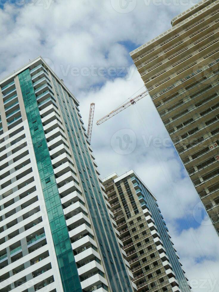 Modern multistory buildings under construction. Unfinished skyscrapers. photo