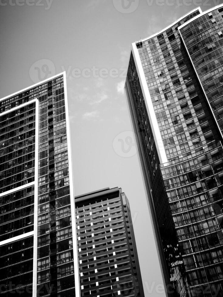 Black and white image of modern architecture with mirrored exterior photo