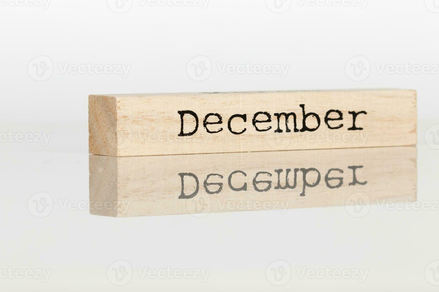 a wooden cube with an inscription December on a white background photo