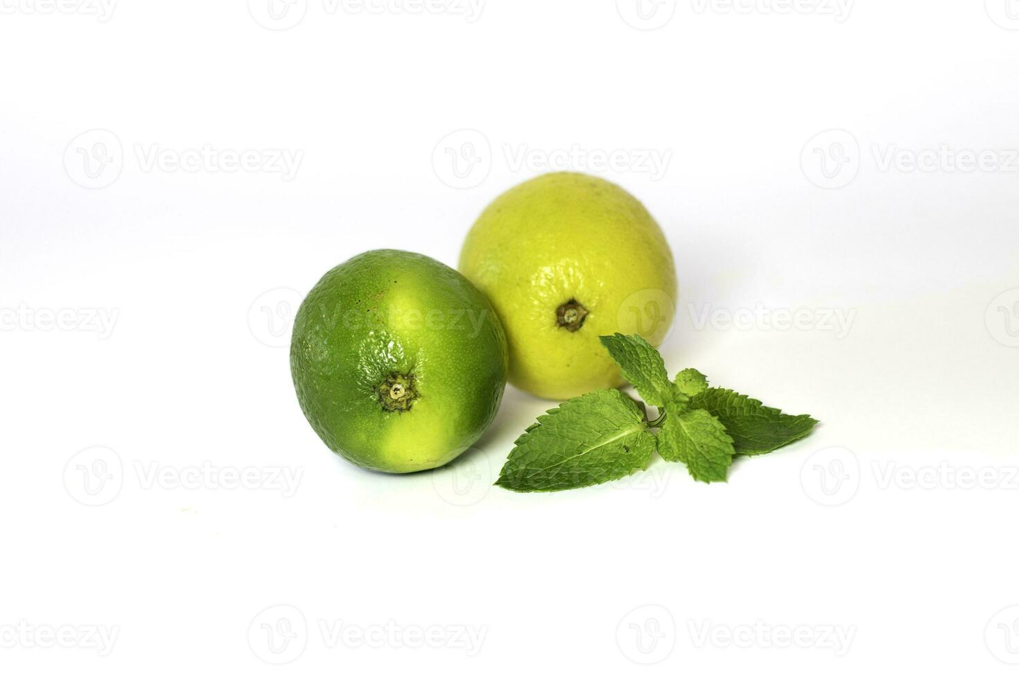 Fresh lime and lemon with mint leaves on white background photo