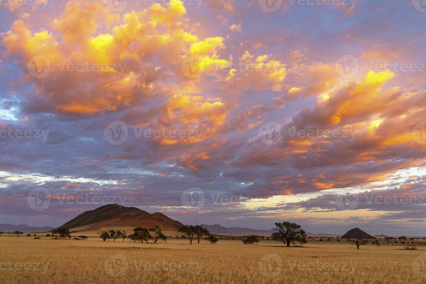 Orange colored clouds at sunrise in Namib Desert photo