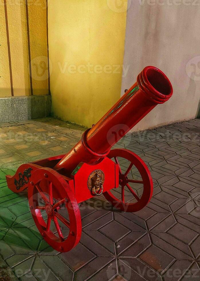 An old cannon placed in front of Ezdan mall. Sitting on cannon is prohibited,Cannon for public display,side view of an old cannon outside an entrance to Ezdan mall photo