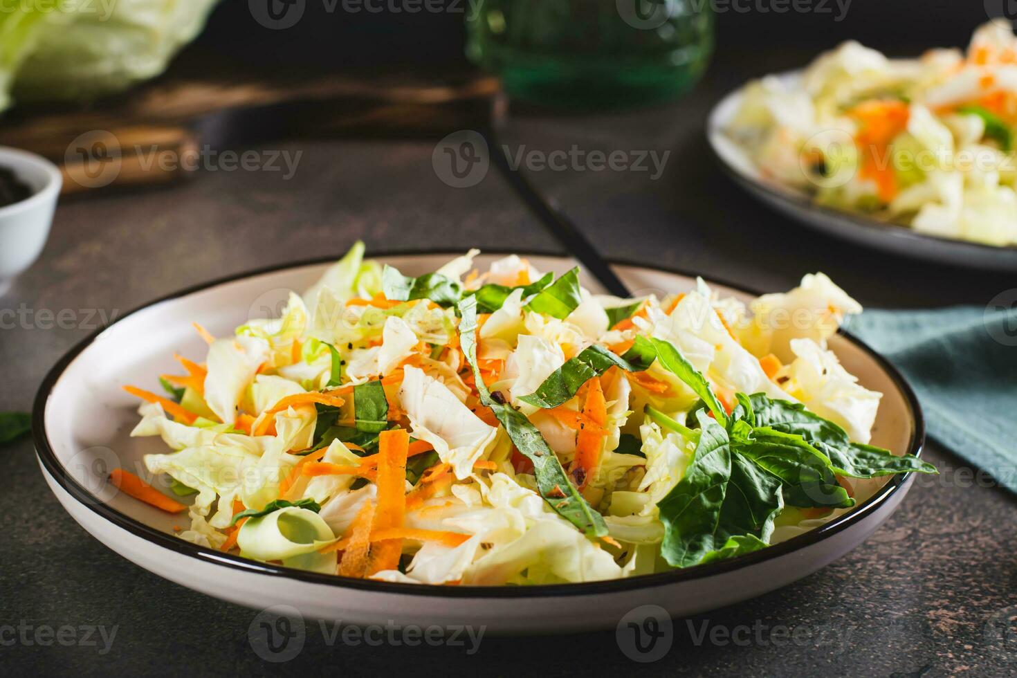 Traditional cole slaw salad of cabbage, carrots and greens on a plate photo