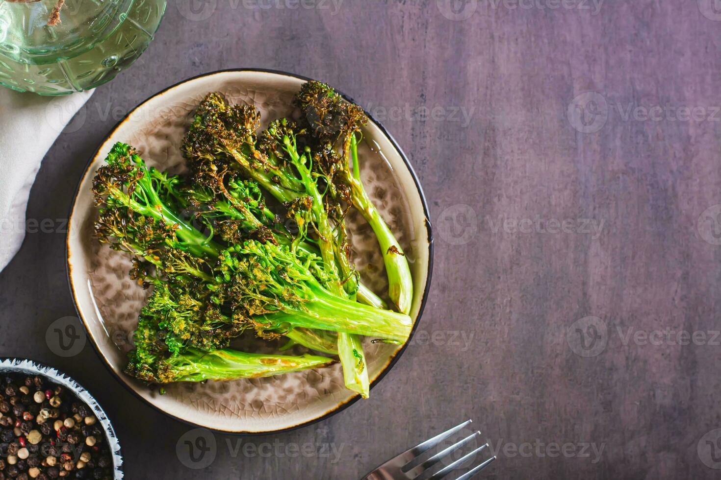 Fried green broccoli sprouts on a plate on the table top view photo