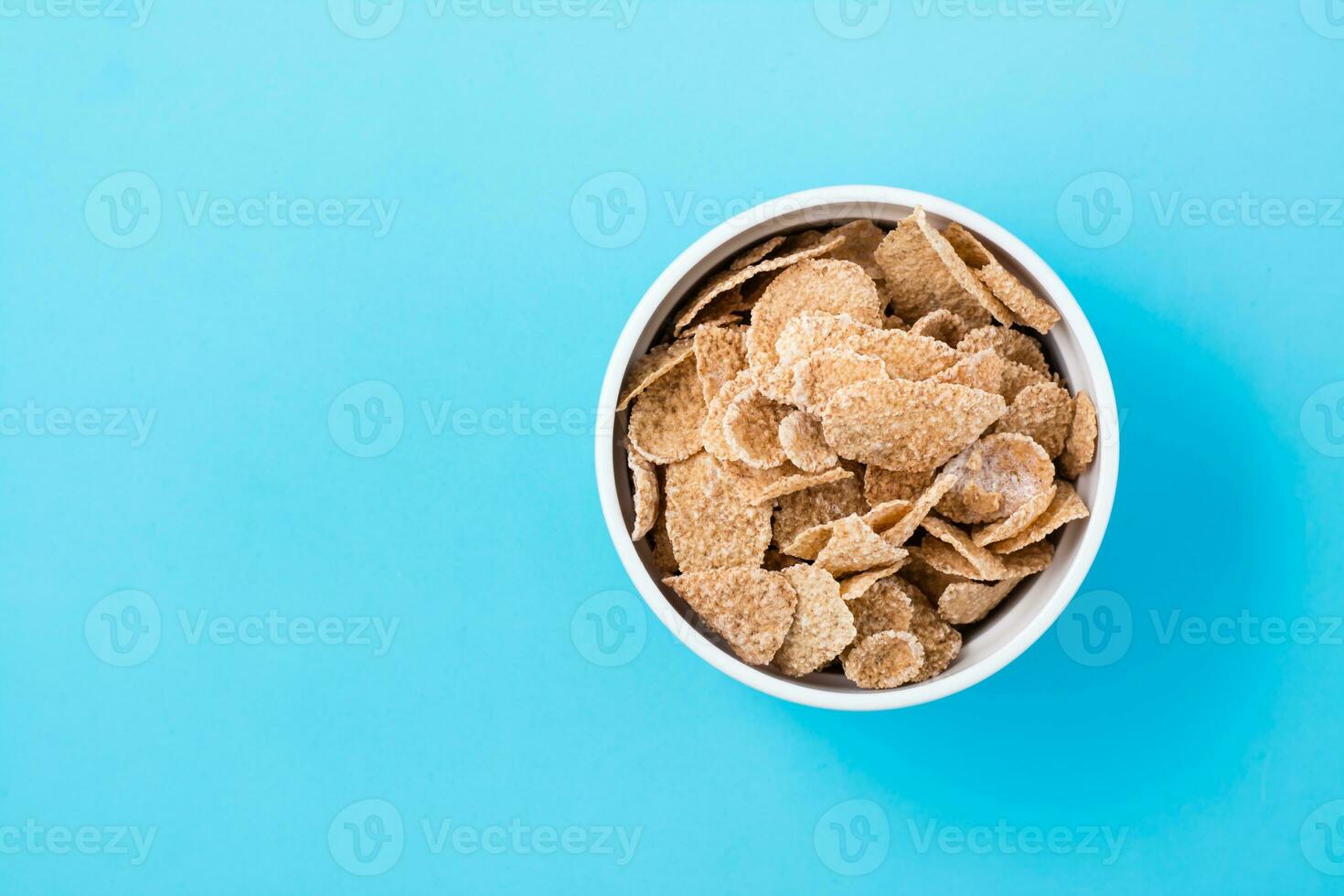 Cereal breakfast cereal dry breakfast in a bowl on a light blue background. Top view photo