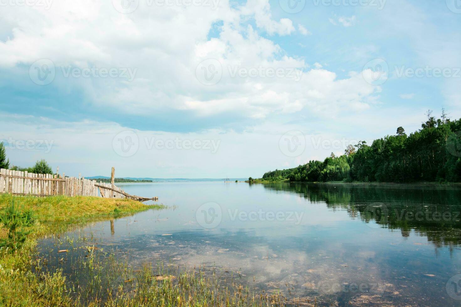 Spring flood on the river. Dirty water flooded the shore and the fence. Disaster photo