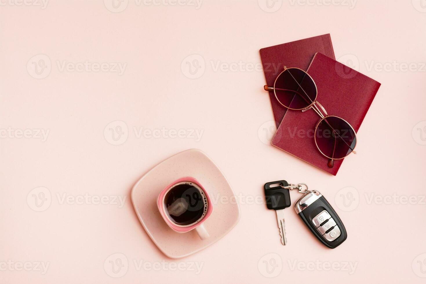 Preparing for a car trip. Passports, sunglasses, car keys and a cup of coffee on a pink background. Local tourism. Top view. Copy space photo