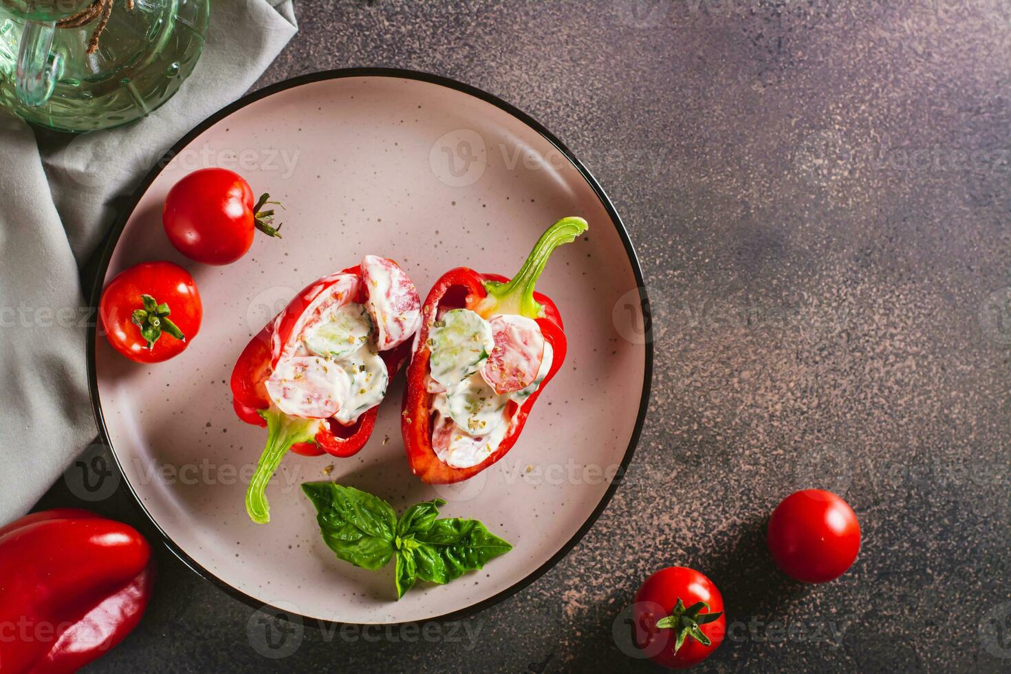Fresh bell pepper stuffed with cucumber, tomato and greek yogurt on a plate top view photo